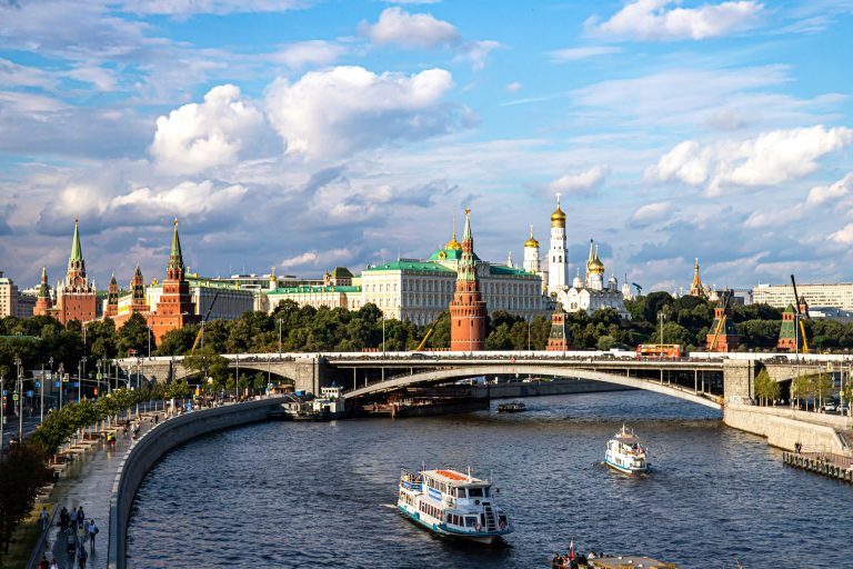 View of the Moscow River with the Kremlin, Cathedral of the Annunciation, and a water tower in the background.